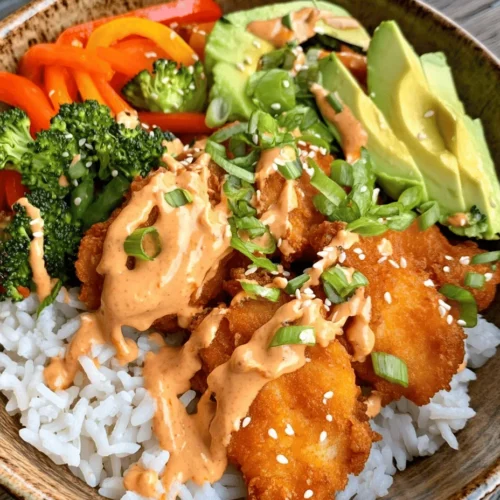 The Bang Bang Chicken Bowl is a vibrant and satisfying dish that has taken the culinary scene by storm. With its harmonious blend of crispy chicken, fresh vegetables, and a creamy, spicy sauce, this bowl is more than just a meal; it’s an experience that tantalizes your taste buds. Whether you’re looking to impress guests at a dinner party or simply whip up something delicious for a weeknight dinner, the Bang Bang Chicken Bowl has you covered. Its appeal lies not only in its mouthwatering flavors but also in the balance of textures—from the crunch of fresh vegetables to the richness of the sauce. It’s no wonder that this dish has become a favorite among food enthusiasts and home cooks alike.