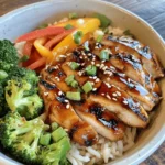 If you're searching for a dish that beautifully balances savory, sweet, and slightly tangy flavors, the Teriyaki Chicken Rice Bowl is a culinary gem that deserves a spot on your dining table. This delightful meal combines tender marinated chicken with fragrant rice and vibrant vegetables, making it not only a feast for the palate but also a visual delight. Originating from Japan, teriyaki refers to a cooking technique that involves grilling or broiling food while basting it in a sweet soy sauce marinade. This method has transcended borders, becoming a beloved favorite in various cuisines around the world.